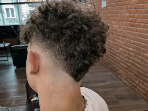 Kręcone włosy z fade — widok z tyłu — Gentlemen Barber Shop Sanok